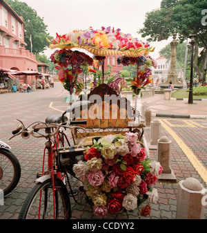Tourist Bicycle rickshaw outside Christ Church in Dutch Square in Malacca Melaka in Malaysia in Far East Southeast Asia. Tourism Occupation Travel Stock Photo