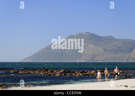 Family walking down beautiful beach in Cape Town Stock Photo