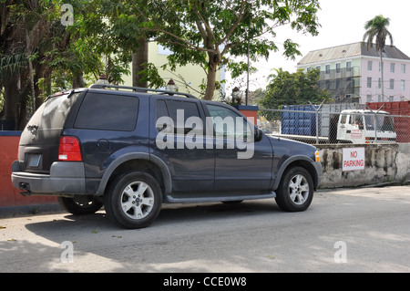 No parking sign and car parked right next to it Stock Photo