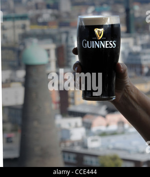 CHEERS. A PINT OF GUINNESS IS ENJOYED IN THE BAR OVERLLOKING THE GUINNESS BREWERY, DUBLIN Stock Photo