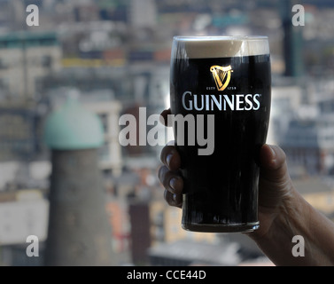 CHEERS. A PINT OF GUINNESS IS ENJOYED IN THE BAR OVERLLOKING THE GUINNESS BREWERY, DUBLIN Stock Photo