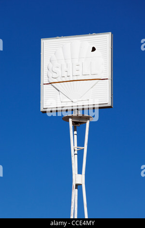 An old cracked and worn Shell service station sign painted white. Stock Photo