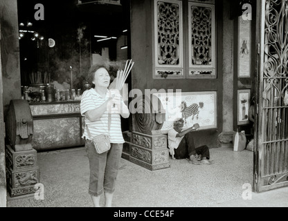 Worship at the Kuan Yin Teng Temple, Temple of the Goddess of Mercy in George Town in Penang Island in Malaysia in Far East Southeast Asia. People Stock Photo