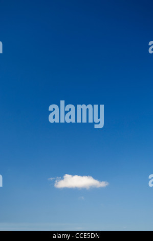 Single white cloud in a clear blue sky. Stock Photo