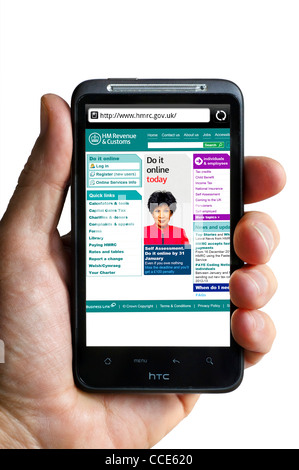 Looking at the HM Revenue and Customs website on an HTC smartphone Stock Photo