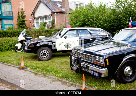 Old police car in grass Stock Photo