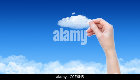 Woman hand hold the cloud against blue sky with clouds. Concept image on cloud computing and ecology theme with copy space. Stock Photo