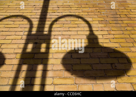 Street lamp shadow on brick wall. Stock Photo