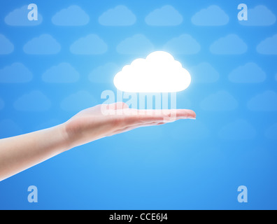 Woman hand share the cloud against blue background with clouds. Concept image on cloud computing theme with copy space. Stock Photo