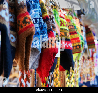 A row of colorful Alpaca wool knit hats in a row at a market Stock Photo