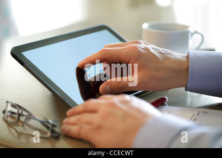 Finger touching screen of a digital tablet Stock Photo