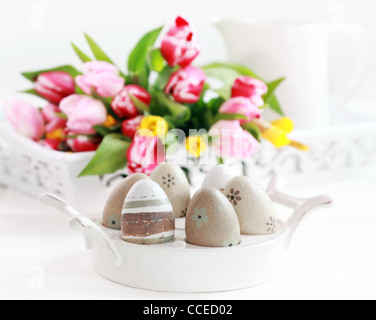Easter eggs with tulips as table decoration Stock Photo