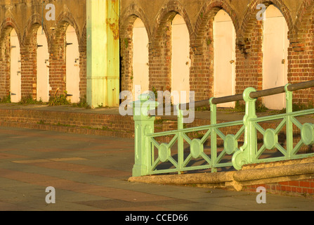 Arches and familiar green railings on Brighton seafront, East Sussex. Stock Photo