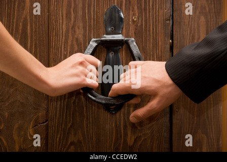 Close up of just married hands opening the door together Stock Photo