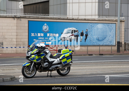 hong kong police force traffic bmw motorcycle in front of a recruitment advert hksar china asia Stock Photo