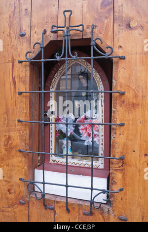 Shrine to the Virgin Mary inset in a wooden door of a house in the historic portion of Quito, Ecuador. Stock Photo