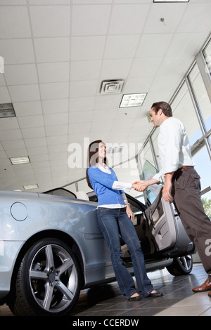 Two hands shaking car in hi-res stock photography and images