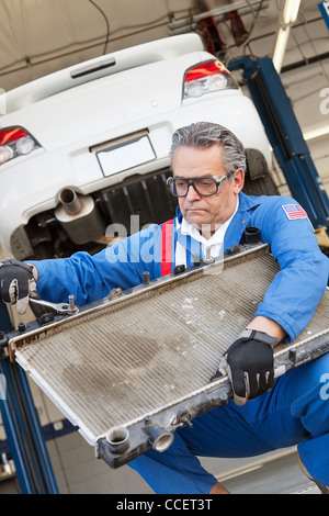 Mechanic working on car part Stock Photo - Alamy