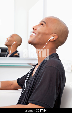 Profile view of man listening music at salon Stock Photo