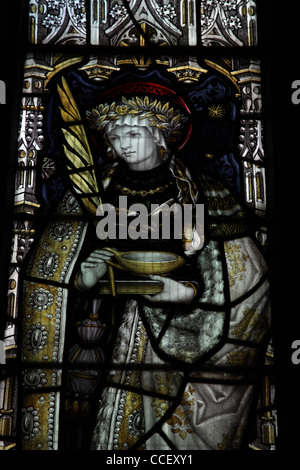 A stained glass window by C E Kempe & Co. depicting Saint Lucy, Church of St Nicholas, Carlton Scoop, Lincolnshire Stock Photo