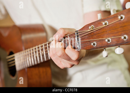 Close-up view of man's hand playing guitar Stock Photo