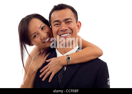 Portrait of Asian couple hugging and smiling isolated over white background Stock Photo