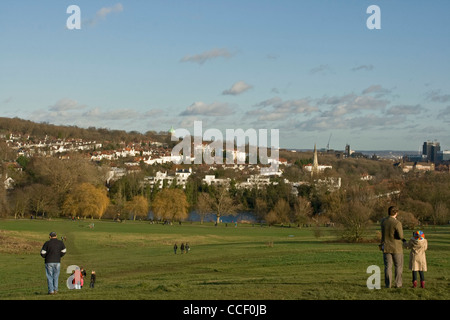 People enjoying leisure time on Hampstead Heath in winter sun London England Europe Stock Photo