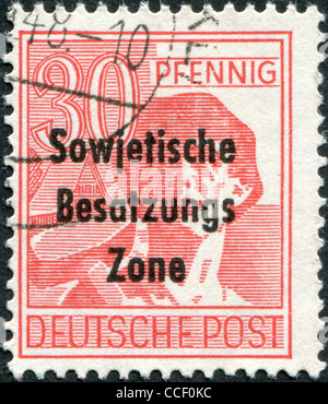 A stamp printed in Germany, is shown worker with a hammer (overprint, the Soviet occupation zone), circa 1948 Stock Photo