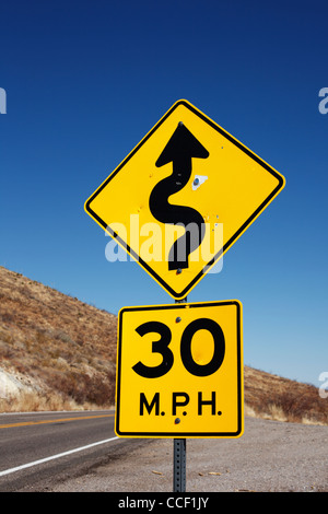 A highway sign indicating curves ahead. Stock Photo