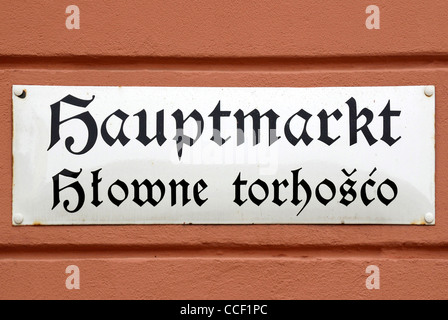 Street sign of Bautzen in German and Sorbian language on the Hauptmarkt - Hlowne torhosco. Stock Photo