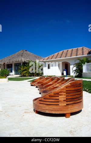 Wooden chairs near swimming pool in hotel Stock Photo