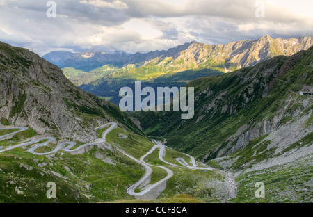 road with tight serpentines on the southern side of the St. Gotthard pass bridging swiss alps at sunset in Switzerland, europe Stock Photo