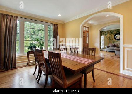 Dining room with yellow walls and foyer view