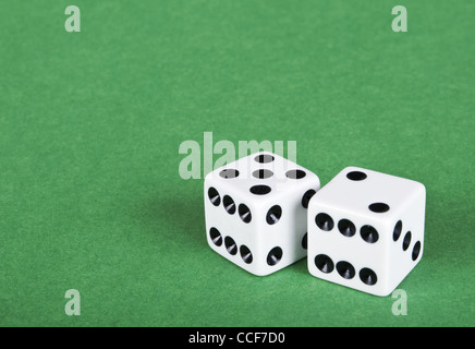 Two white dices on green background Stock Photo