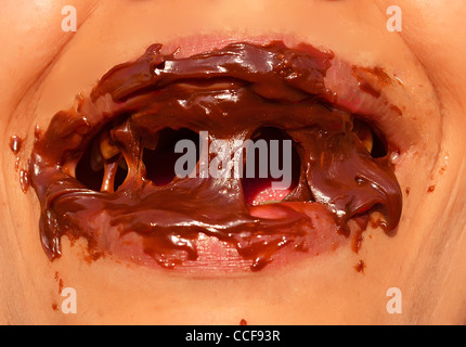 lady having her mouth full of chocolate Stock Photo