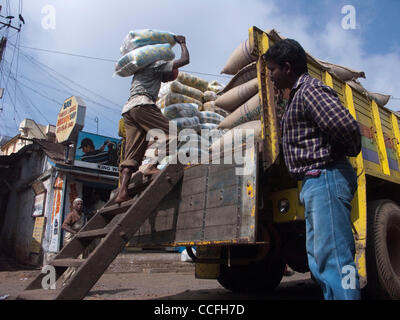 Laborers load trucks in Kannur Tamil Nadu state India Stock Photo