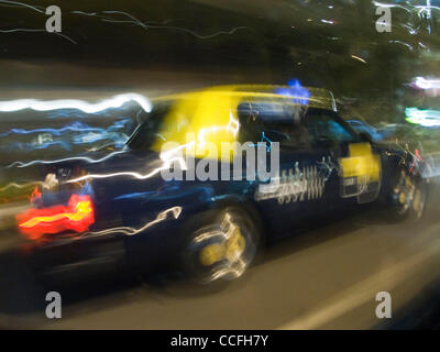 Blurred view of city traffic from inside a taxi in Singapore on a rainy night Stock Photo