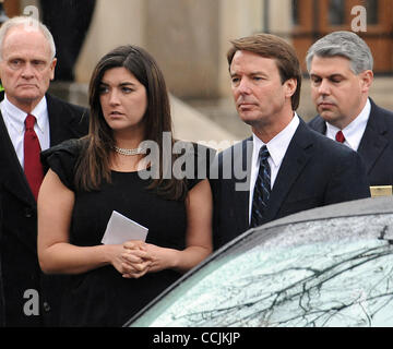 Dec 11, 2010 - Raleigh, North Carolina; USA - Former Senator JOHN EDWARDS and his daughter CATE EDWARDS look on as the casket his loaded into the hearse after the funeral service for ELIZABETH EDWARDS who passed away earlier in the week from a long battle with cancer.  The funeral service was held a Stock Photo