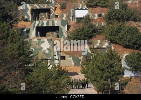 Nov 28, 2010 - Yeonpyeong Island, South Korea - South Korean Marines move near camouflaged armored vehicles. Dozens of artillery shells fired by North Korea struck the island on November 23, resulting in four deaths and further injuries and prompting return fire from South Korean troops. (Credit Ima Stock Photo