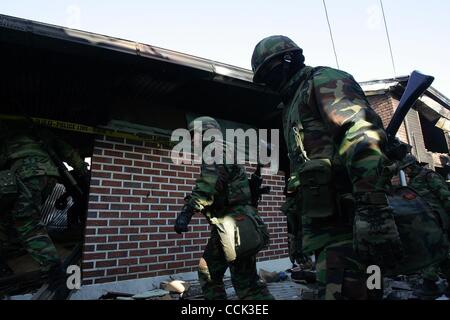 Nov 28, 2010 - Yeonpyeong Island, South Korea - South Korean marines search for a rocket dud in the broken village. Dozens of artillery shells fired by North Korea struck the island on November 23, resulting in four deaths and further injuries and prompting return fire from South Korean troops. (Cre Stock Photo