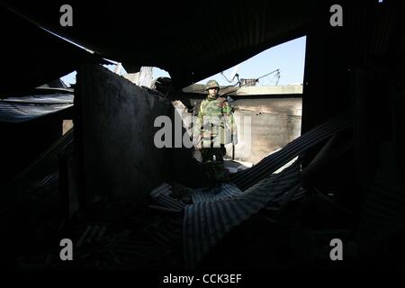 Nov 28, 2010 - Yeonpyeong Island, South Korea - South Korean marines search for a rocket dud in the broken village. Dozens of artillery shells fired by North Korea struck the island on November 23, resulting in four deaths and further injuries and prompting return fire from South Korean troops. (Cre Stock Photo