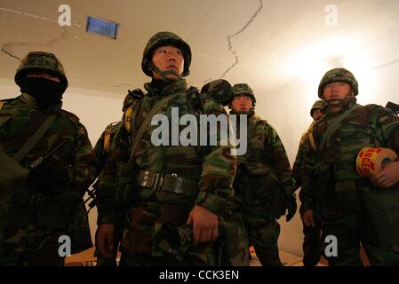 Nov 28, 2010 - Yeonpyeong Island, South Korea - South Korean marines take shelter in a bunker after siren and broadcast warnings go off. The marines had been searching the village for a rocket dud. Dozens of artillery shells fired by North Korea struck the island on November 23, resulting in four de Stock Photo