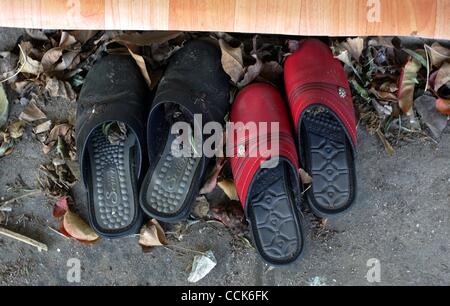 Dec 1, 2010 - Yeonpyeong Island, South Korea - Shoes remain at a house which residents have deserted following an artillery exchange between North and South Korea. Dozens of artillery shells fired by North Korea struck the island on November 23, resulting in four deaths and further injuries and prom Stock Photo