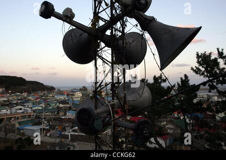 Nov 26, 2010 - Yeonpyeong Island, South Korea - Destroyed houses below siren warning system speakers .following an artillery exchange between North and South Korea. Dozens of artillery shells fired by North Korea struck the island on November 23, resulting in four deaths and further injuries and pro Stock Photo