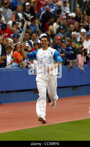 Jun 16, 2004; Los Angeles, CA, USA; Actor TOM CRUISE carries the Olympic Torch inside Dodger stadium June 16, 2004 in Los Angeles, Calif. The global Olympic Torch Relay began the first of its four cities that will host the torch in the U.S. continuing around the globe, ending in Athens, Greece. Stock Photo