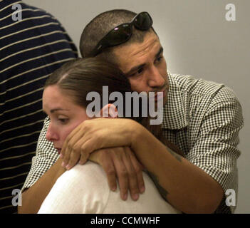 Laura Danielle Medina's uncle Eddie Medina (top) and his fiancee Heidi Warfel both of Oakland, Calif., wait for the start of Laura Danielle Medina's arraignment in connection with the death of Michelle Dickerson at the Alameda County Superior Courthouse in Hayward, Calif., on Friday, June 25, 2004.  Stock Photo
