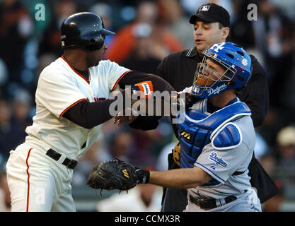 Michael Tucker tries to get past catcher David Ross after an Eric Gagne pitch knocked him down in the 8th inning. Home plate Andy Fletcher tries to keep peace. The San Francisco Giants swept the Los Angeles Dodgers Thursday June 24, 2004 with a 9-3 victory.   (Contra Costa Times/Karl Mondon) Stock Photo