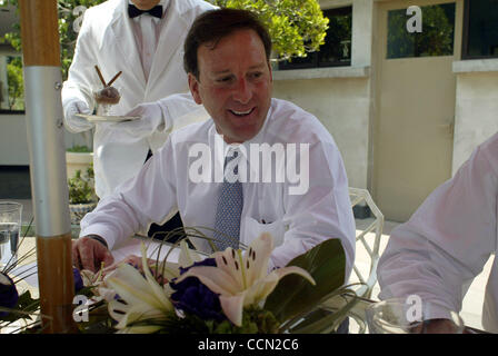 Tony Garza, US Ambassador to Mexico, is served his chocolate ice cream after lunch, poolside at the Ambassador's residence in Mexico City on Thursday July 29, 2004.  (Photo By Sarah Martone) Stock Photo