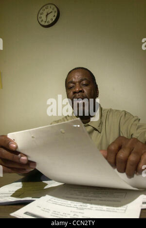 Don Anderson 50, of Los Angeles, Calif., reads from his hospital and prison records during an interview at the Atascadero State Hospital in Atascadero, Calif., on Tuesday, July 27, 2004. Anderson is one of the inmates at the State Hospital who refuses to enroll in the Sexually Violent Predators prog Stock Photo