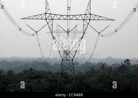 CISEENG, BOGOR, INDONESIA - AUGUST 16, 2004  View of power lines and towers around rural and village areas in South Jakarta and Bogor, West Java. Poor people have left Jakarta due to high cost of land then dwell on free land such as one underneath power lines and structures. They risk their life, as Stock Photo